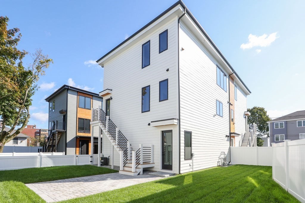 31 Hall Street, Unit 2 Waltham, MA 02453 - Photo 22 of 23 a front view of a house with a yard