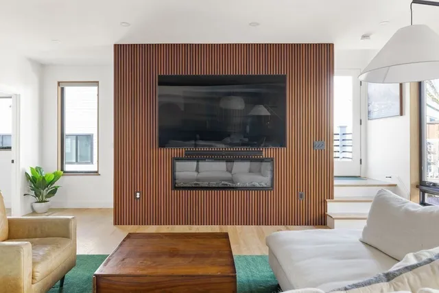 a living room with a couch a rug and a window