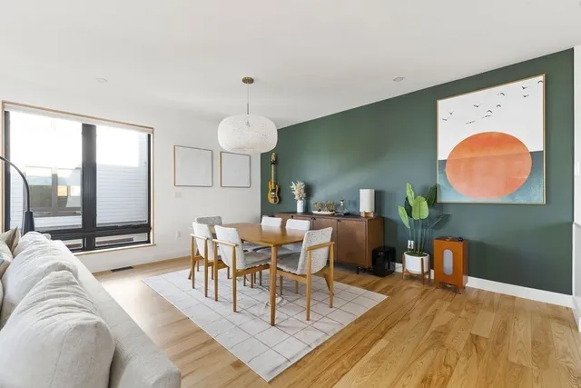 a view of a dining room with furniture and wooden floor
