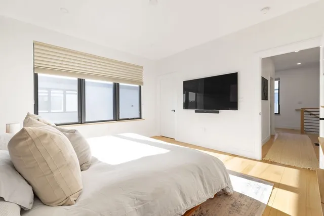 a bedroom with a bed and a flat screen tv
