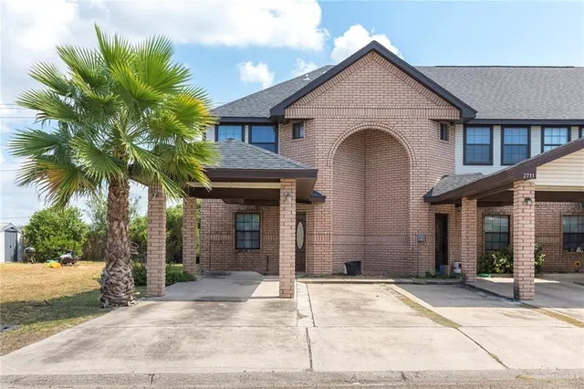 a view of a house with a yard and plants
