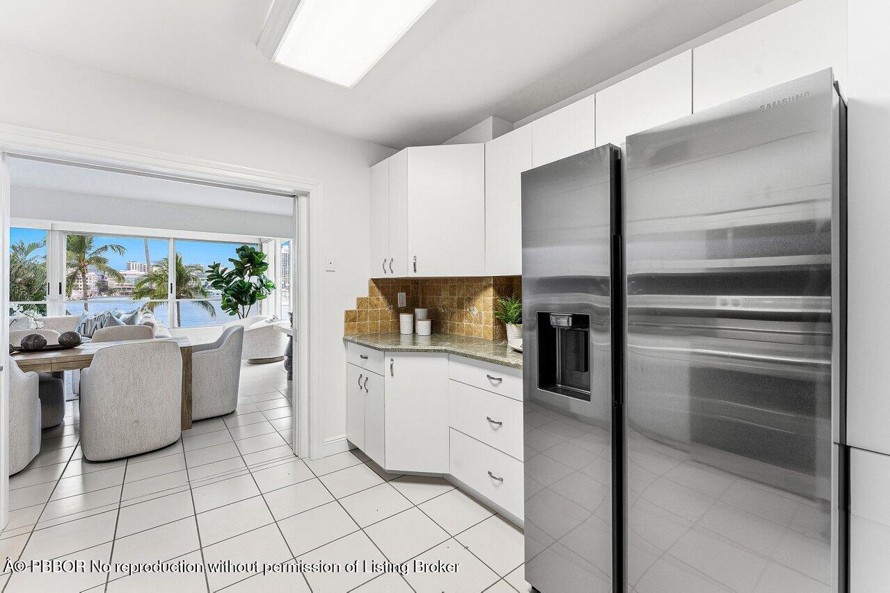 44 Cocoanut Row, Unit 120B Palm Beach, FL 33480 - Photo 13 of 42 a kitchen with a refrigerator and cabinets