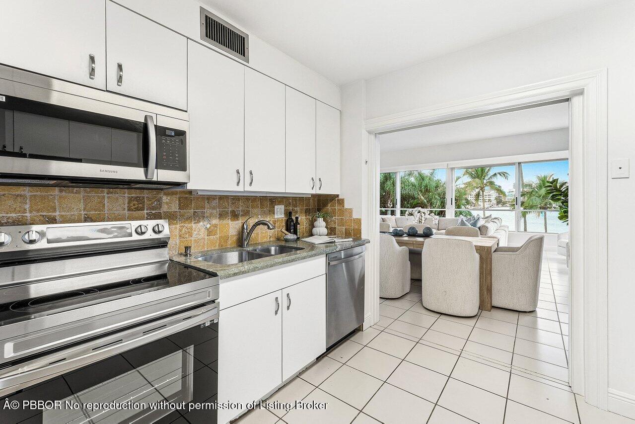 44 Cocoanut Row, Unit 120B Palm Beach, FL 33480 - Photo 15 of 42 a kitchen with a stove and white cabinets