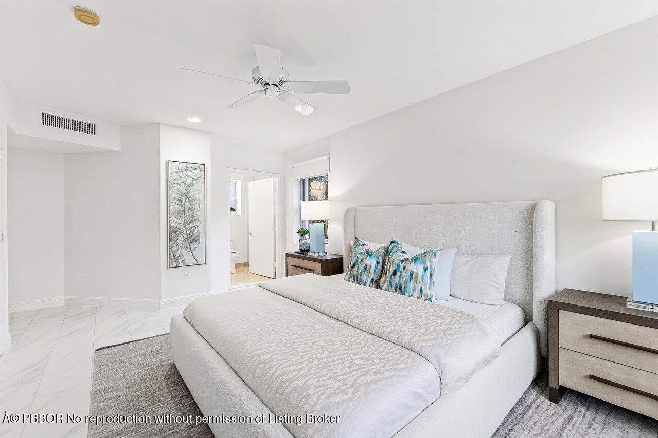 44 Cocoanut Row, Unit 120B Palm Beach, FL 33480 - Photo 18 of 42 a bedroom with a large bed and a chandelier