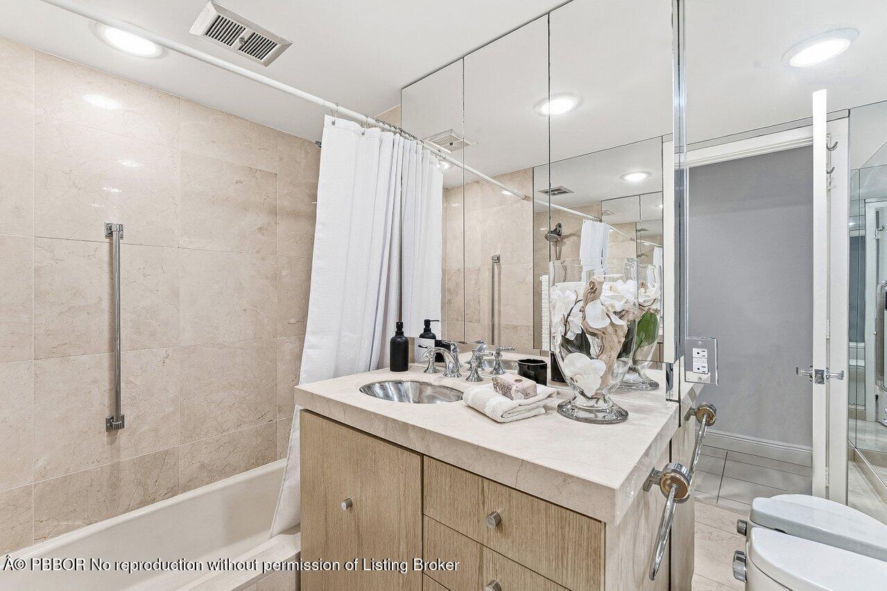 44 Cocoanut Row, Unit 120B Palm Beach, FL 33480 - Photo 22 of 42 a bathroom with a double vanity sink toilet mirror and shower