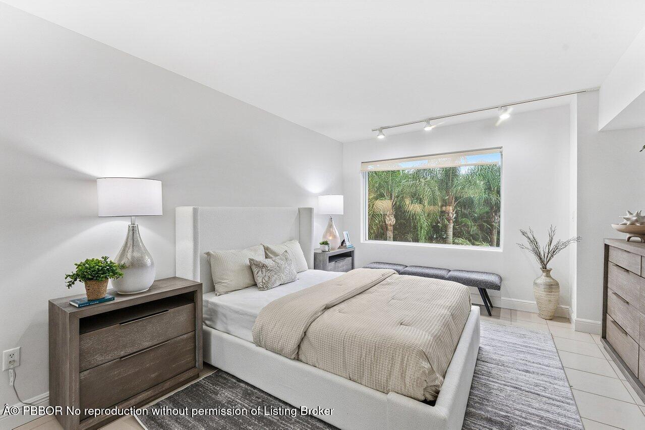 44 Cocoanut Row, Unit 120B Palm Beach, FL 33480 - Photo 26 of 42 a bed room with a bed window and a table