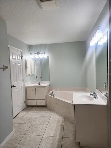a bathroom with a bathtub sink and mirror