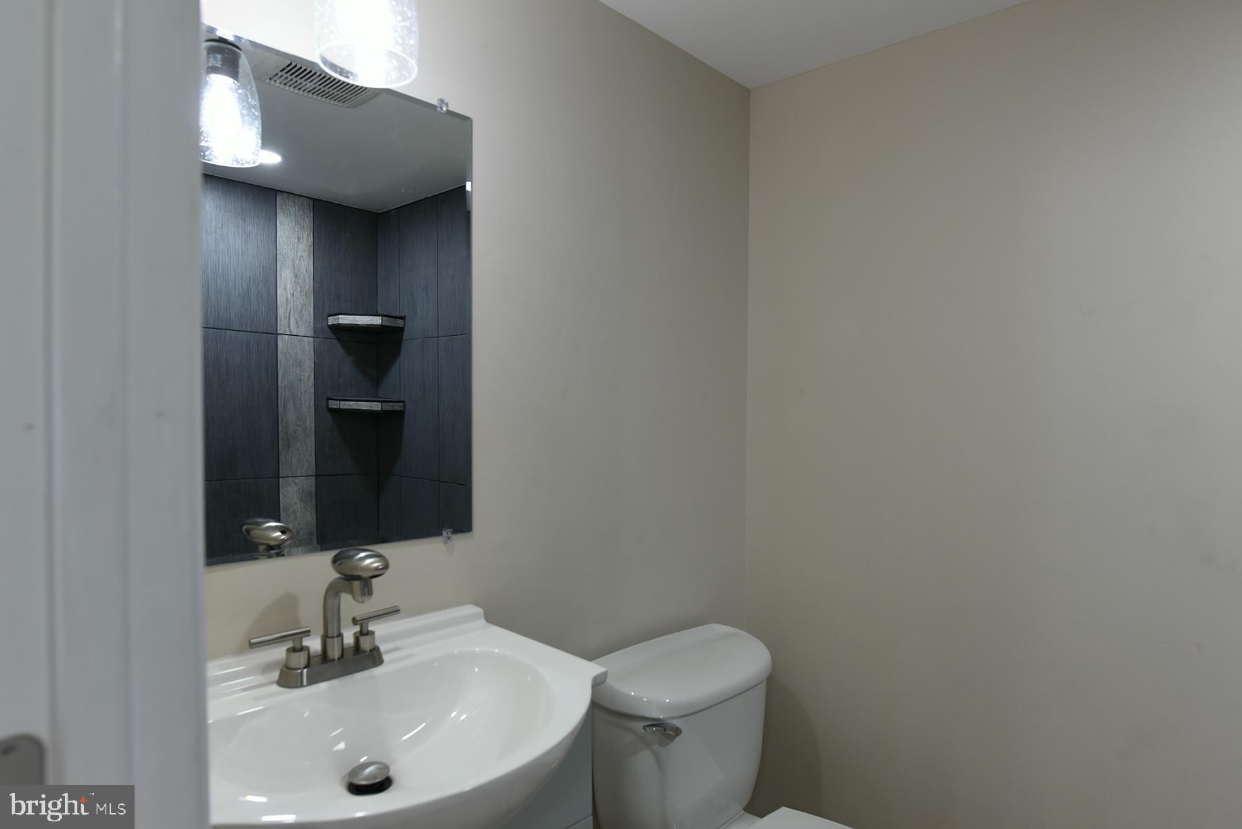 70 Nottingham Road Hagerstown, MD 21740 - Photo 19 of 39 a bathroom with a sink and mirror with toilet