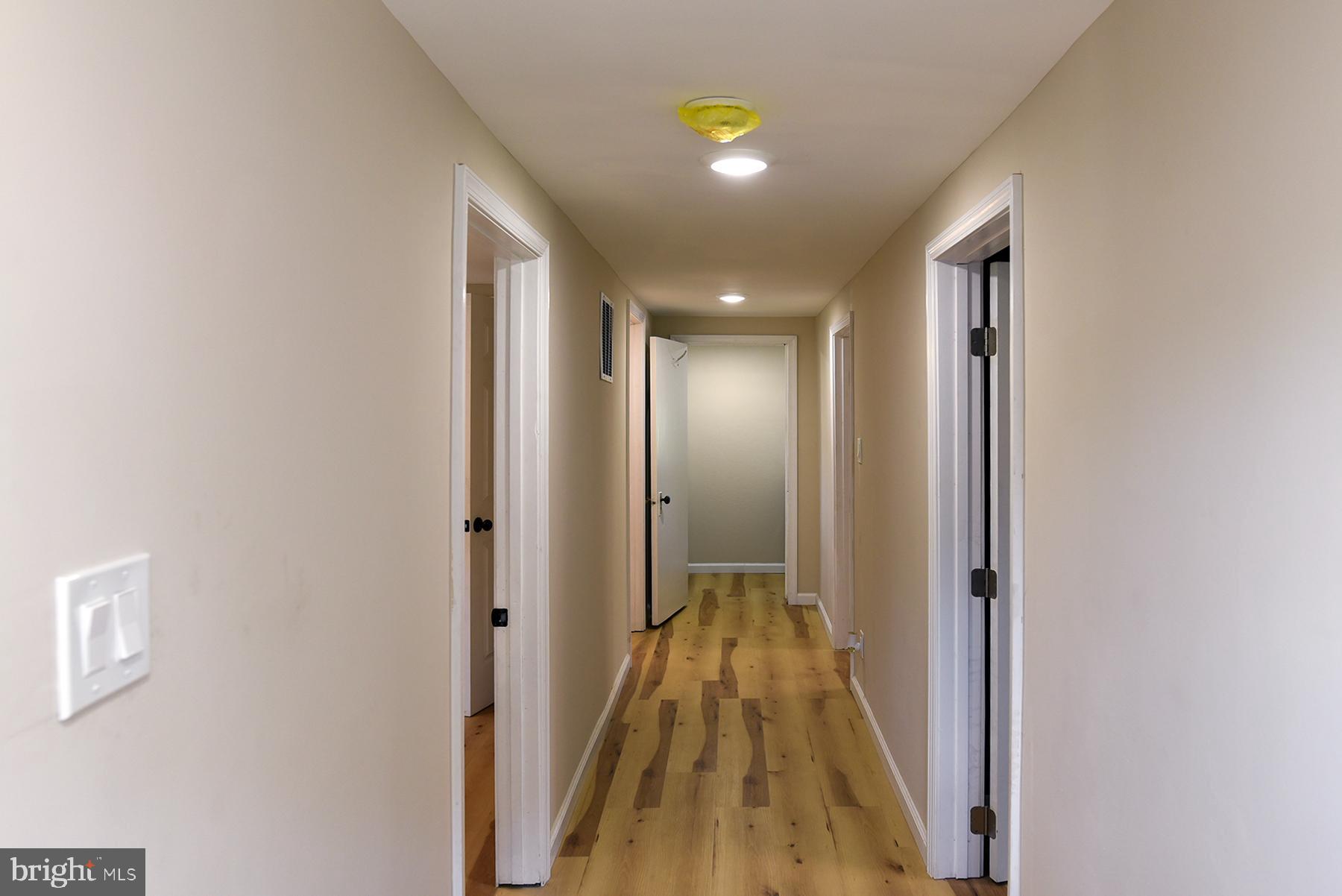 70 Nottingham Road Hagerstown, MD 21740 - Photo 22 of 39 a view of a hallway with wooden floor and a bathroom