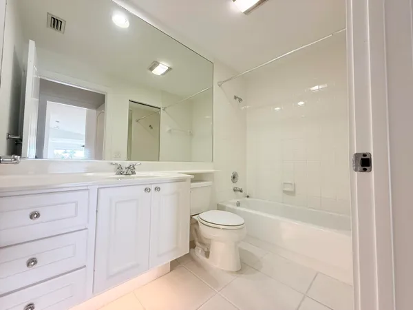 a bathroom with a double vanity sink toilet and shower