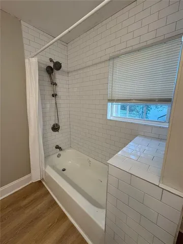 a bathroom with a bathtub and shower