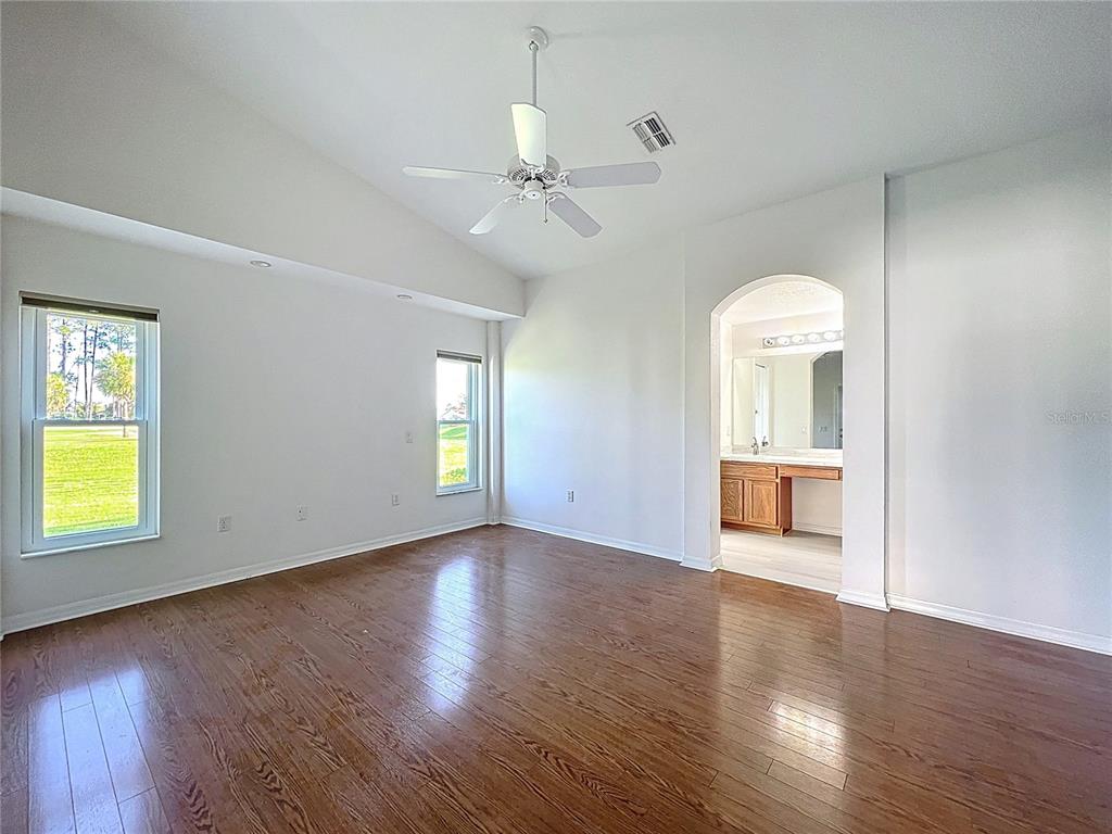 11644 Spindrift Loop Hudson, FL 34667 - Photo 27 of 99 a view of an empty room with a window and wooden floor