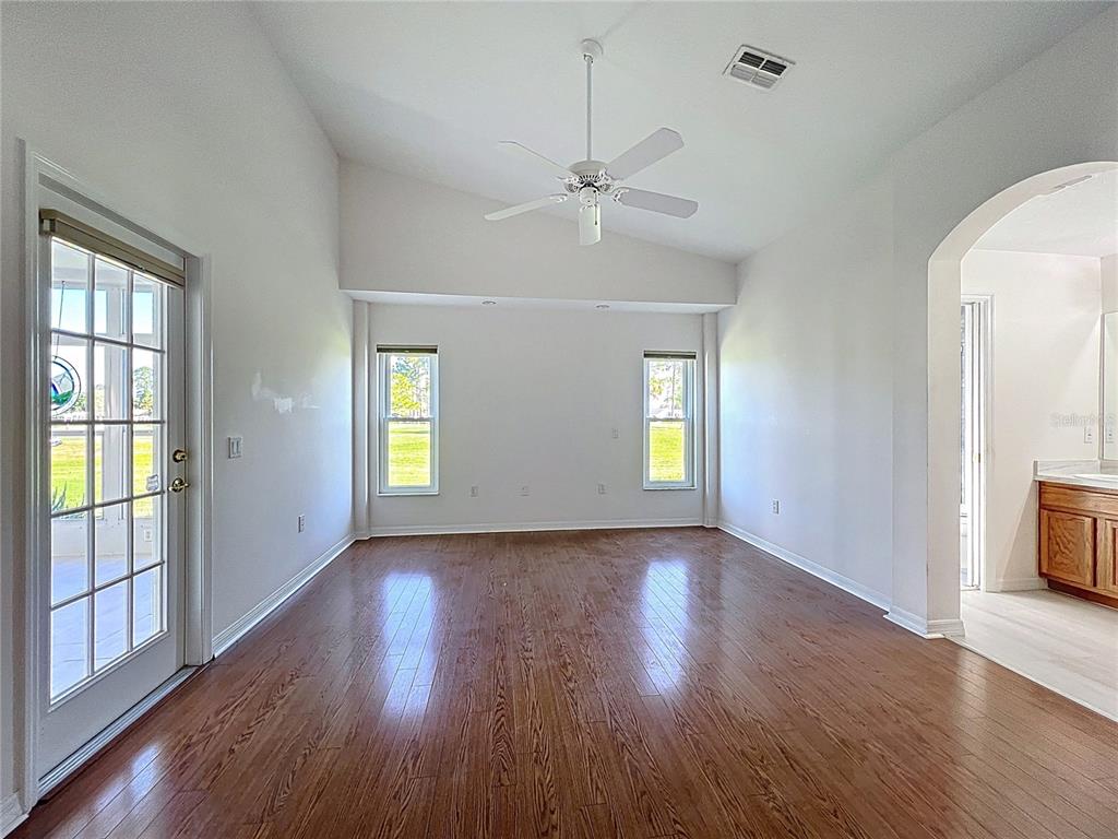11644 Spindrift Loop Hudson, FL 34667 - Photo 41 of 99 a view of an empty room with wooden floor and a window