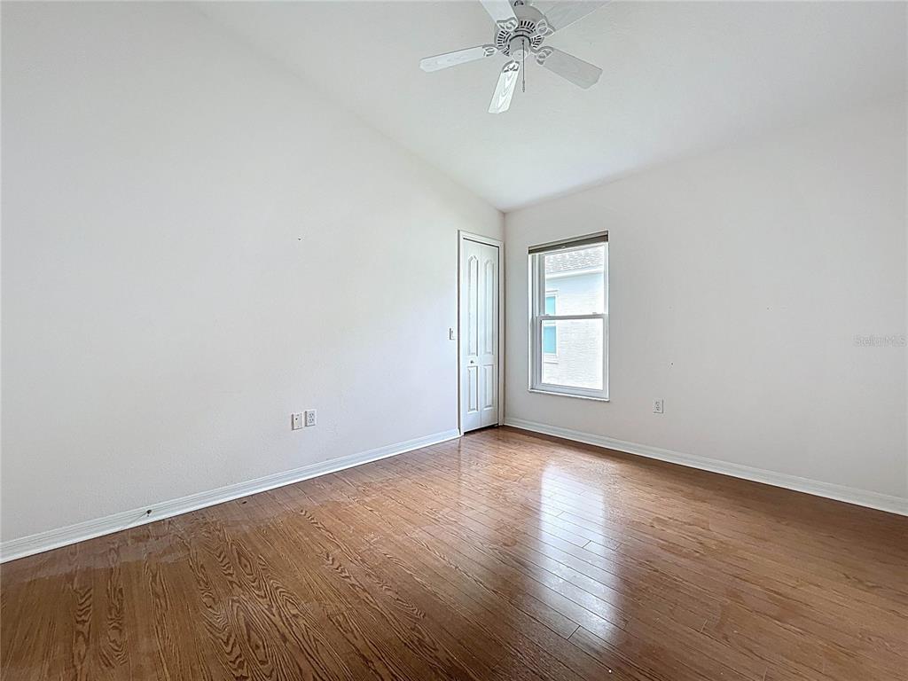 11644 Spindrift Loop Hudson, FL 34667 - Photo 44 of 99 a view of an empty room with wooden floor and a window