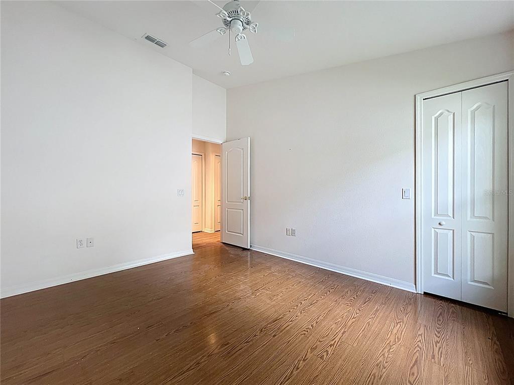 11644 Spindrift Loop Hudson, FL 34667 - Photo 45 of 99 an empty room with wooden floor and windows
