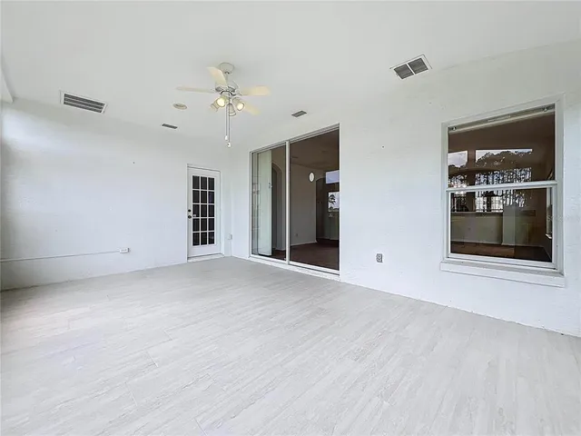 an aerial view of residential houses with outdoor space and parking