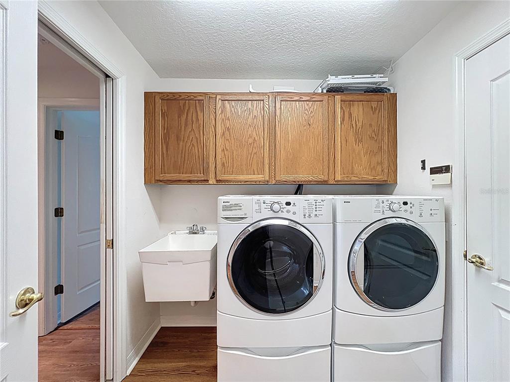 11644 Spindrift Loop Hudson, FL 34667 - Photo 53 of 99 a utility room with sink dryer and washer