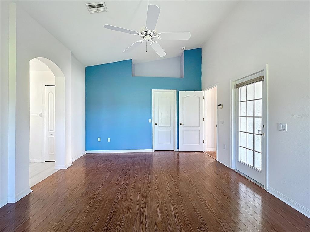 11644 Spindrift Loop Hudson, FL 34667 - Photo 69 of 99 a view of an empty room with a window and wooden floor