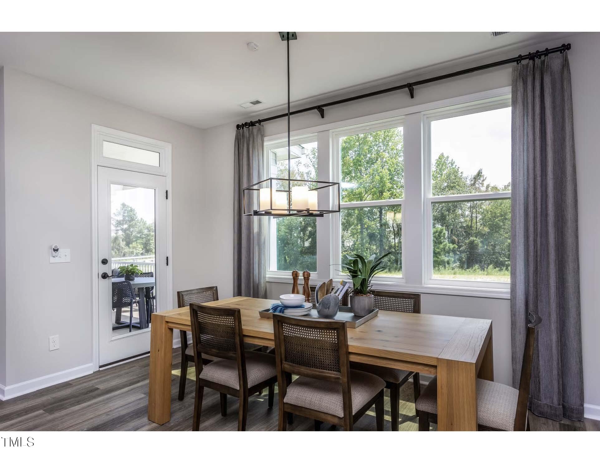 33 White Azalea Way Benson, NC 27504 - Photo 11 of 25 a view of a dining room with furniture window and outside view