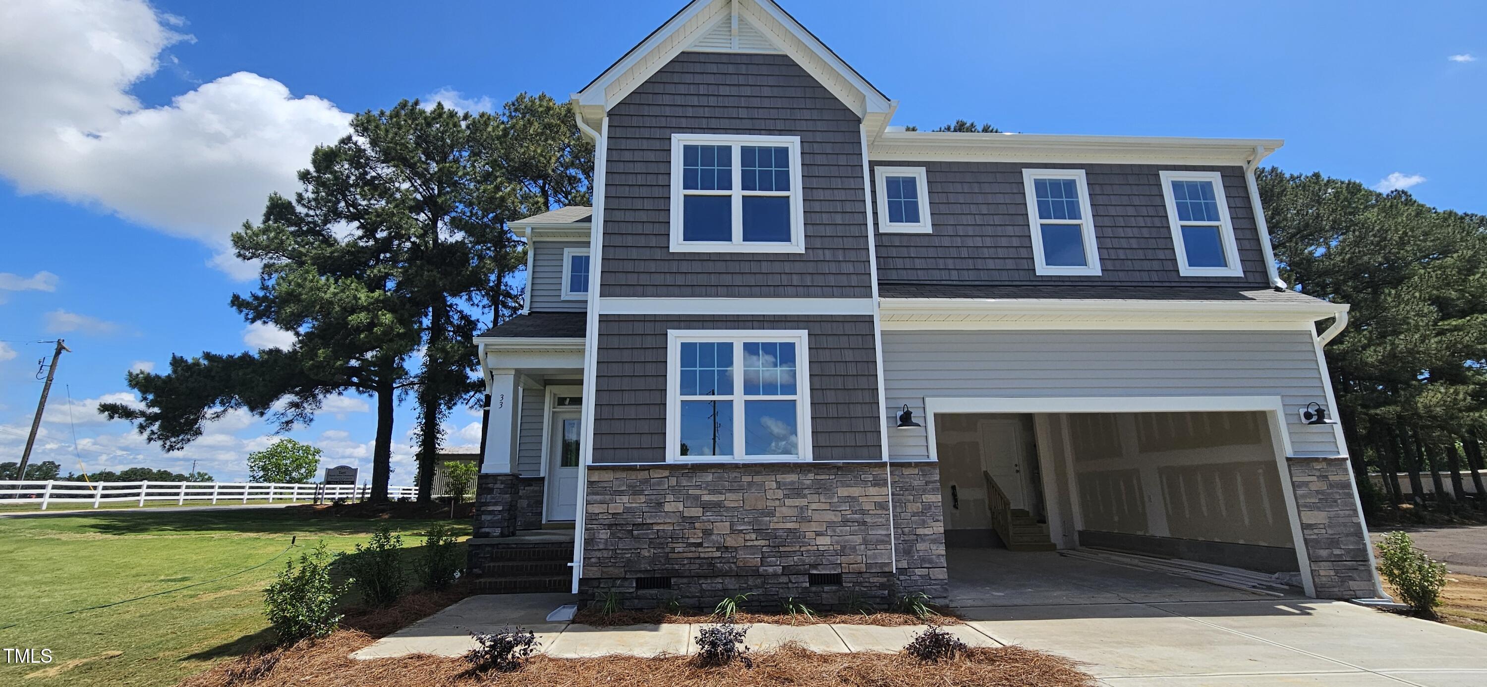 33 White Azalea Way Benson, NC 27504 - Photo 2 of 25 a front view of a house with garden