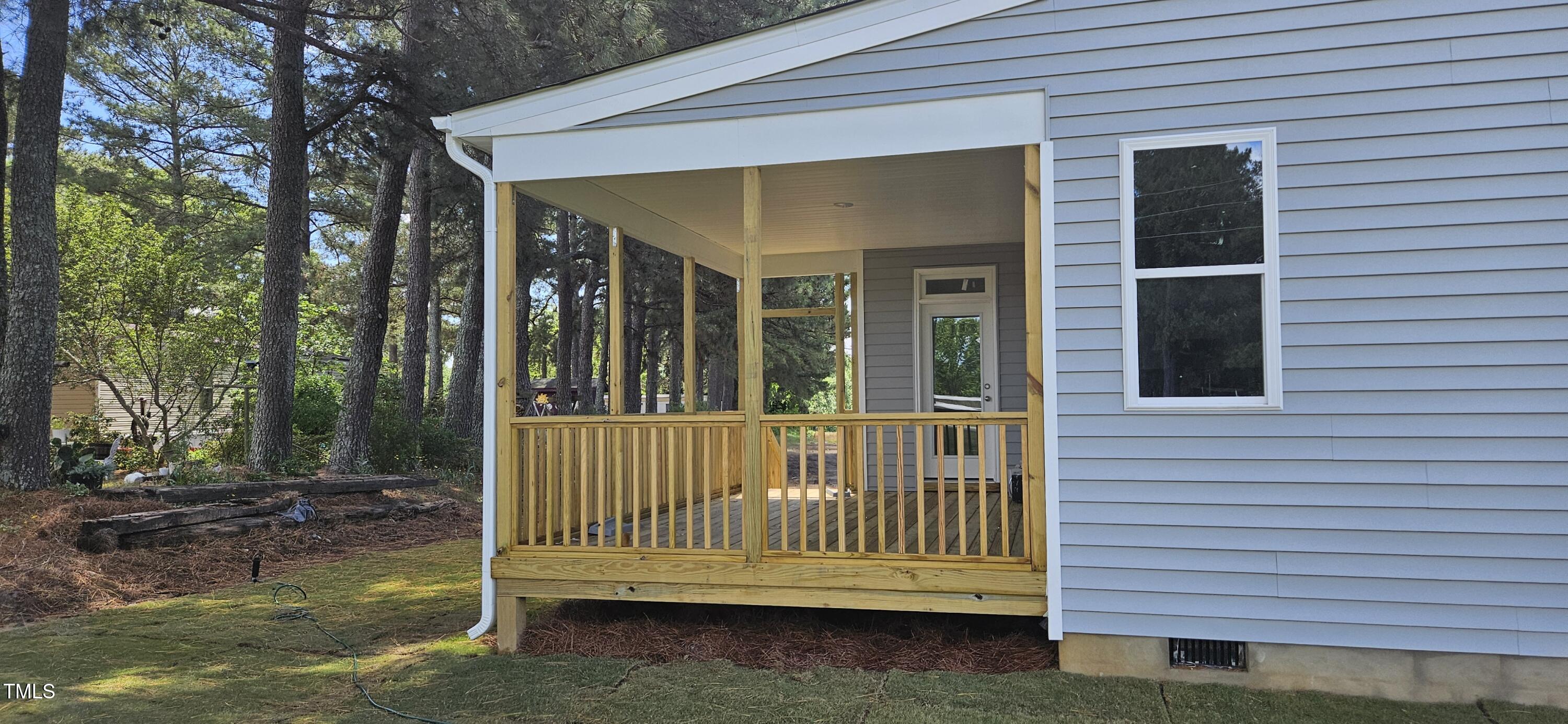 33 White Azalea Way Benson, NC 27504 - Photo 3 of 25 a view of porch with a bench