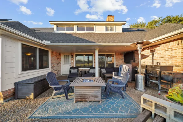 a view of a patio with table and chairs and potted plants