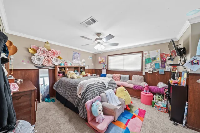 a bed room with a bed and a flat screen tv