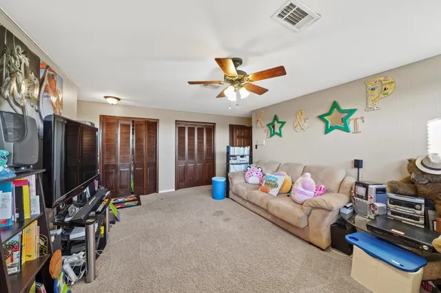 a bedroom with furniture and a flat screen tv