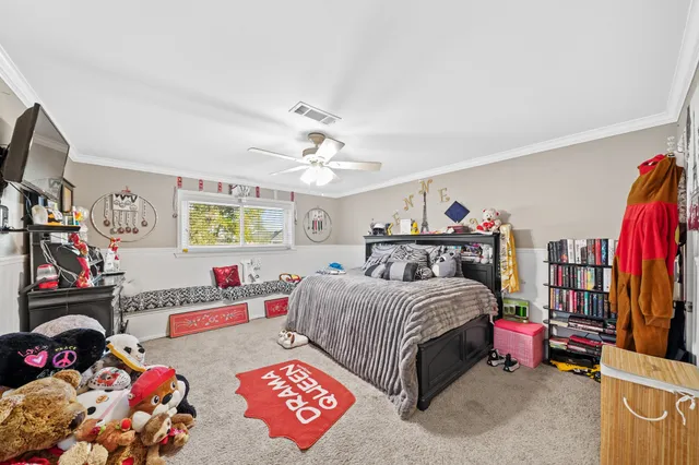 a bedroom with bed and a chandelier