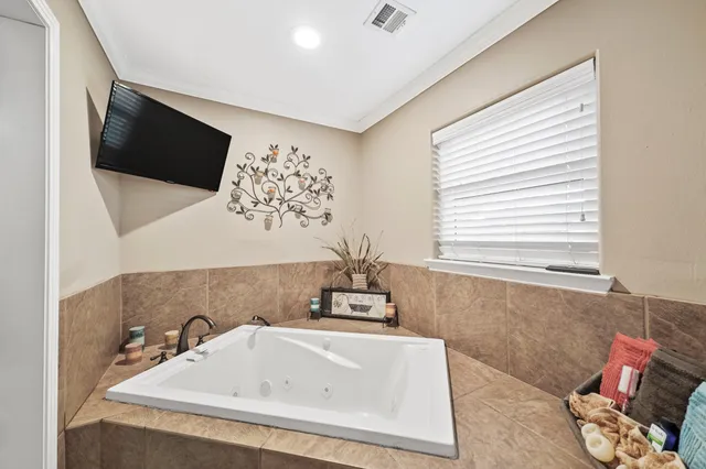 a bathroom with a bathtub and a window