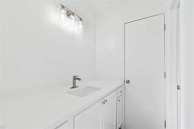 a bathroom with a sink and mirror