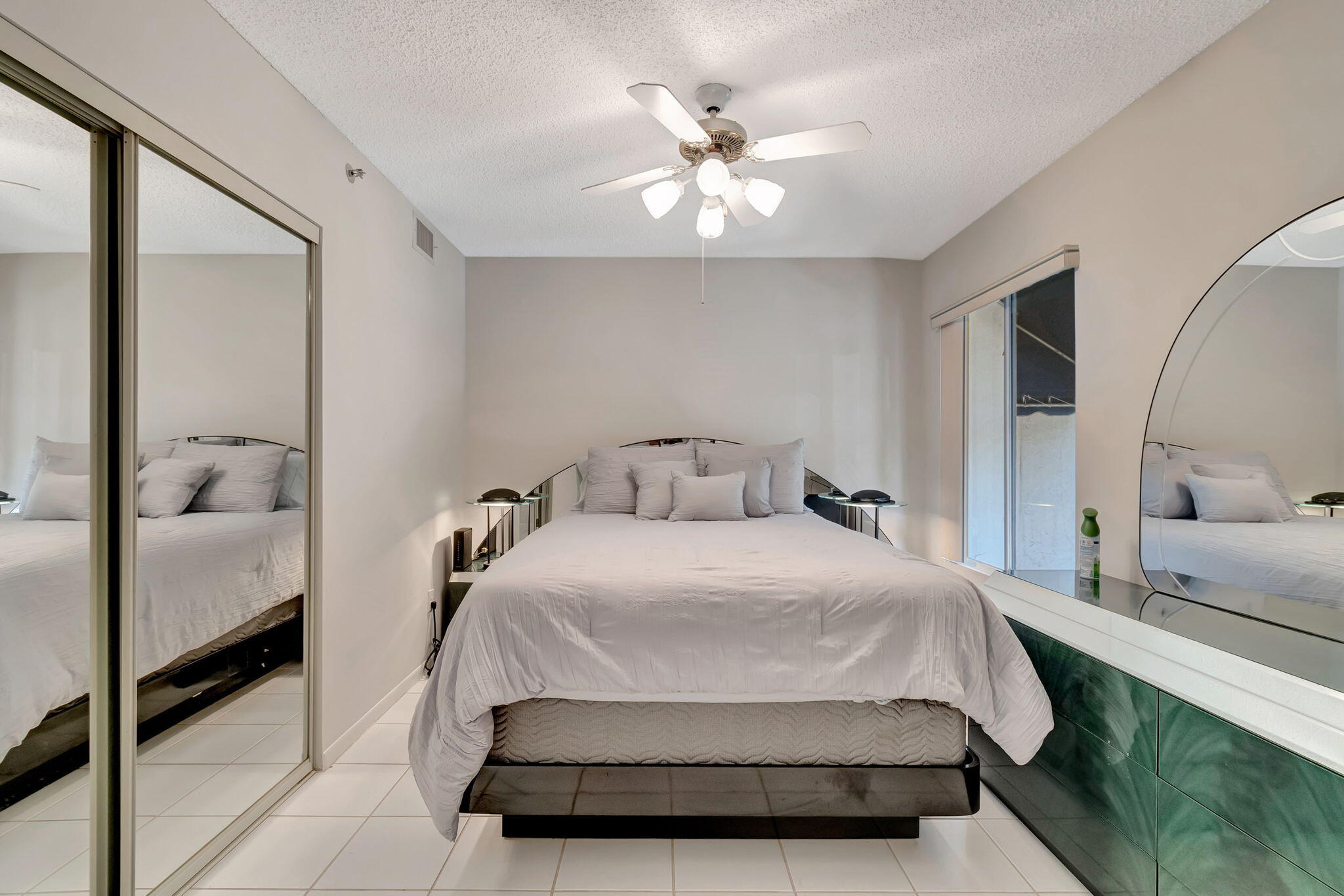 280 Northwest 67th Street, Unit B207 Boca Raton, FL 33487 - Photo 20 of 22 a bedroom with a bed and a chandelier