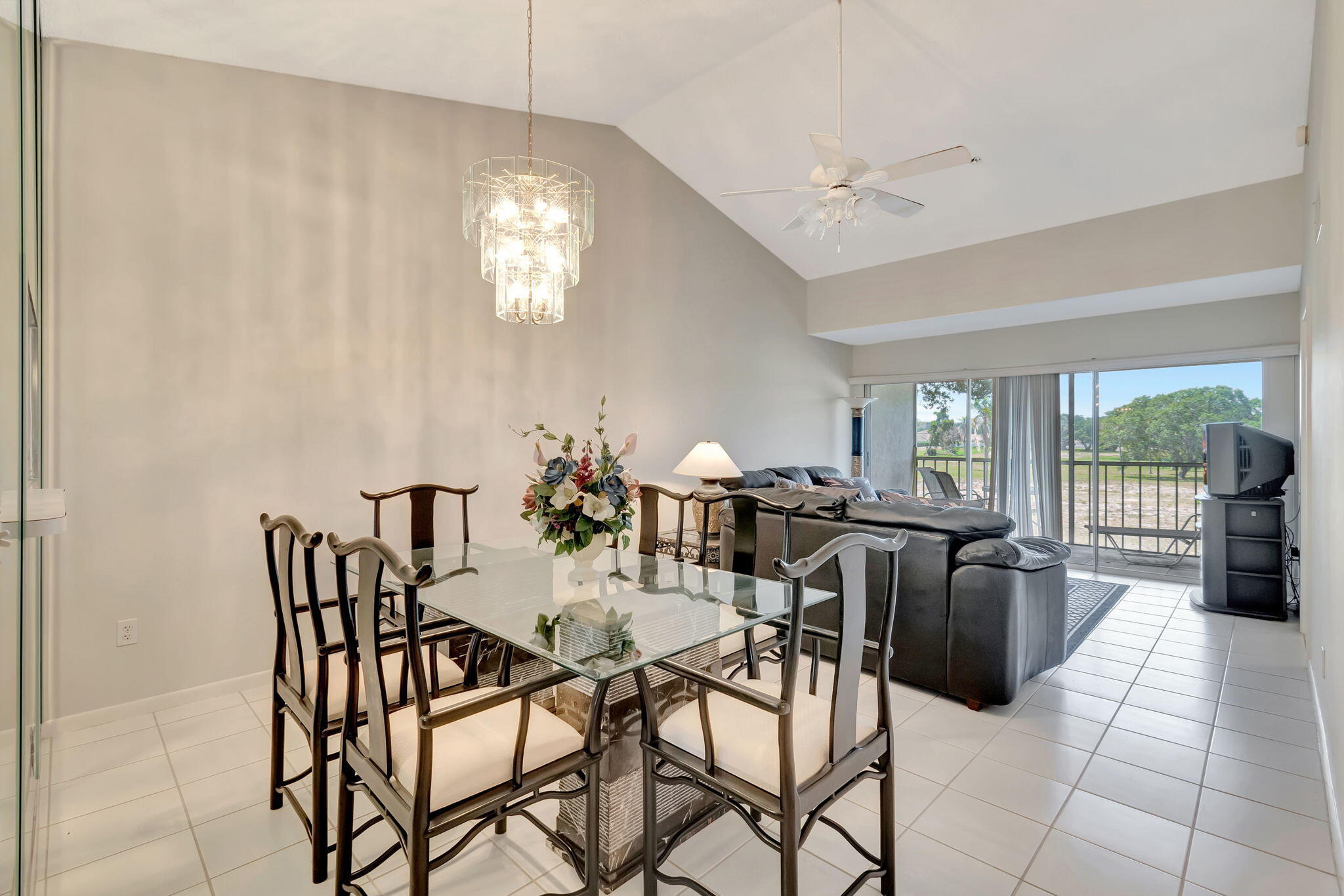 280 Northwest 67th Street, Unit B207 Boca Raton, FL 33487 - Photo 2 of 22 a view of a dining room with furniture and a chandelier
