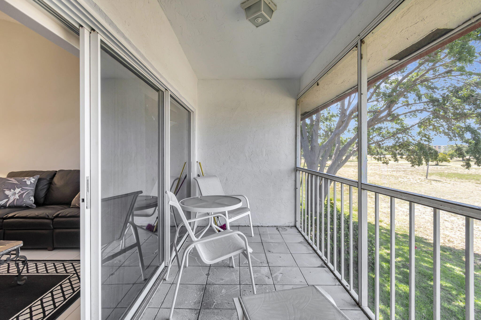 280 Northwest 67th Street, Unit B207 Boca Raton, FL 33487 - Photo 8 of 22 a balcony with chairs and outdoor view