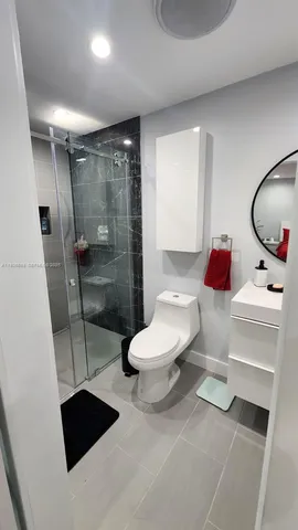 a bathroom with a toilet sink and shower