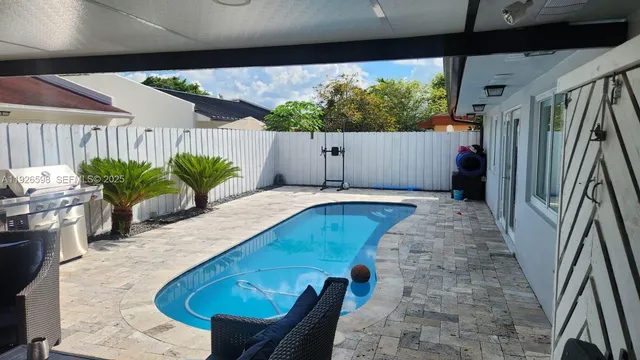 a view of a backyard with potted plants