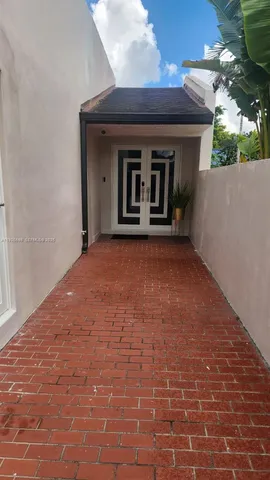 a view of a house with a small yard and floor to ceiling window
