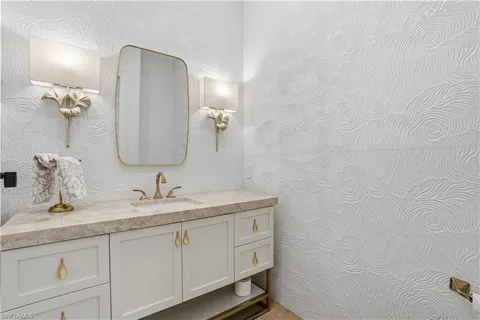 a bathroom with a double vanity sink and mirror