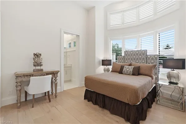 a bedroom with a bed and a table