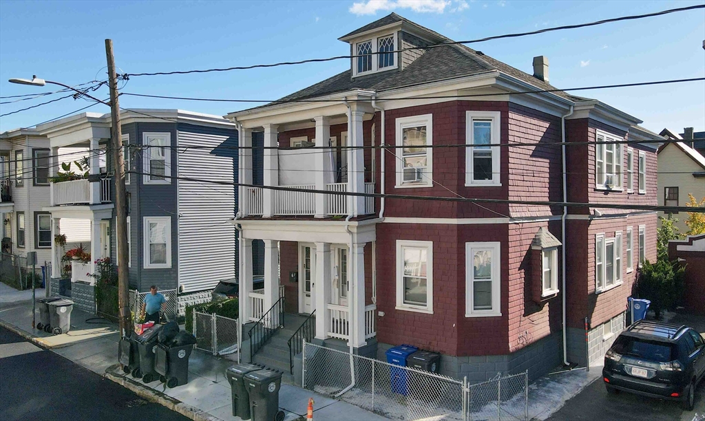 29 Cottage Street Chelsea, MA 02150 - Photo 1 of 24 a front view of a building with glass windows