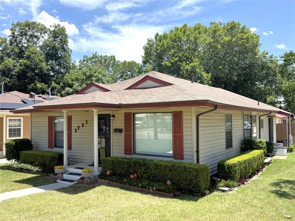 7721 Mohawk Drive Dallas, TX 75235 - Photo 1 of 1 a front view of a house with a yard and garage