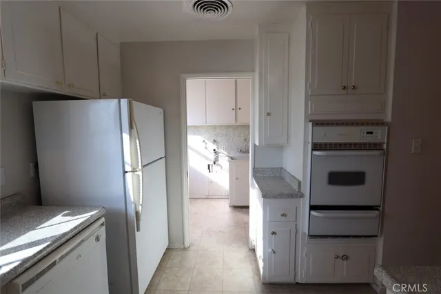 a kitchen with cabinets and stainless steel appliances