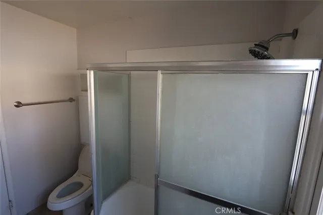 a bathroom with a toilet and a shower