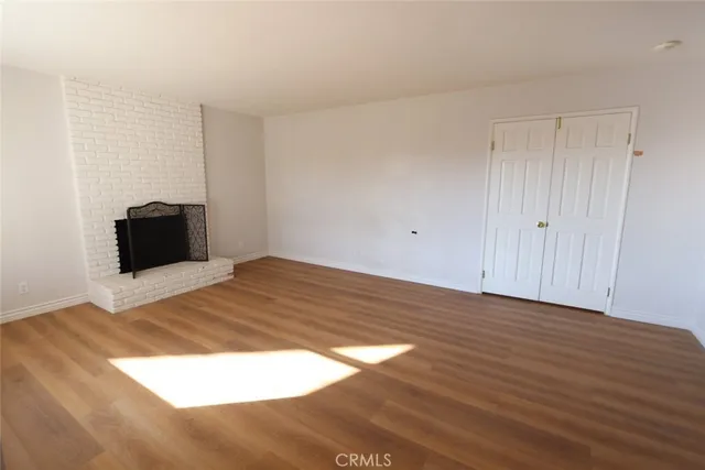 a room with a bed and wooden floor