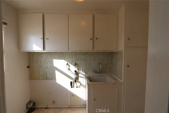 a kitchen with a sink and cabinets