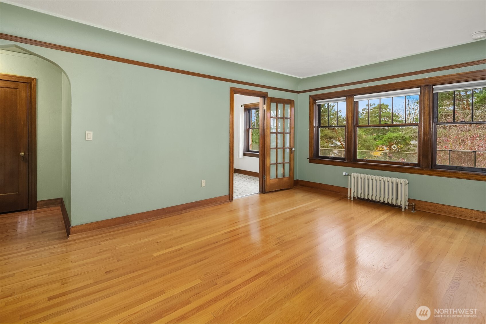 1631 16th Avenue, Unit 309 Seattle, WA 98122 - Photo 1 of 23 a view of an empty room with a window and wooden floor
