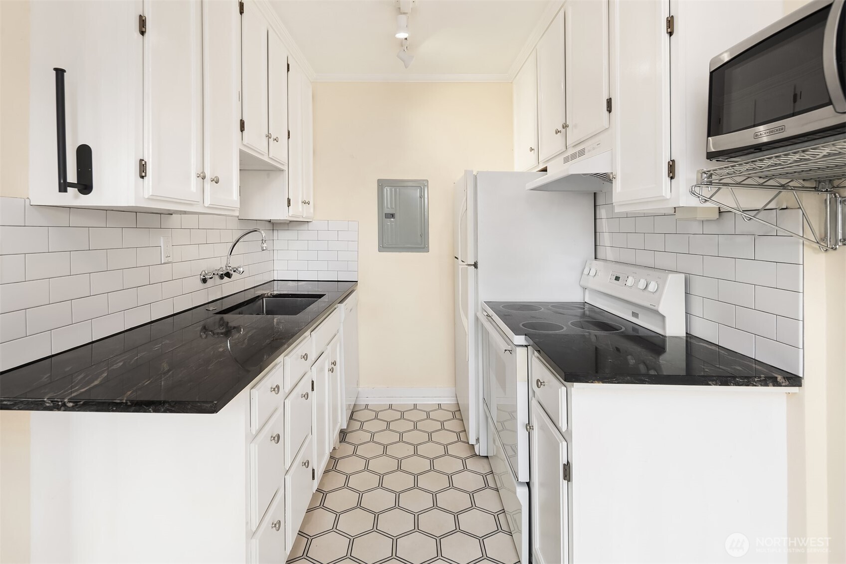1631 16th Avenue, Unit 309 Seattle, WA 98122 - Photo 11 of 23 a kitchen with granite countertop a sink a stove and cabinets