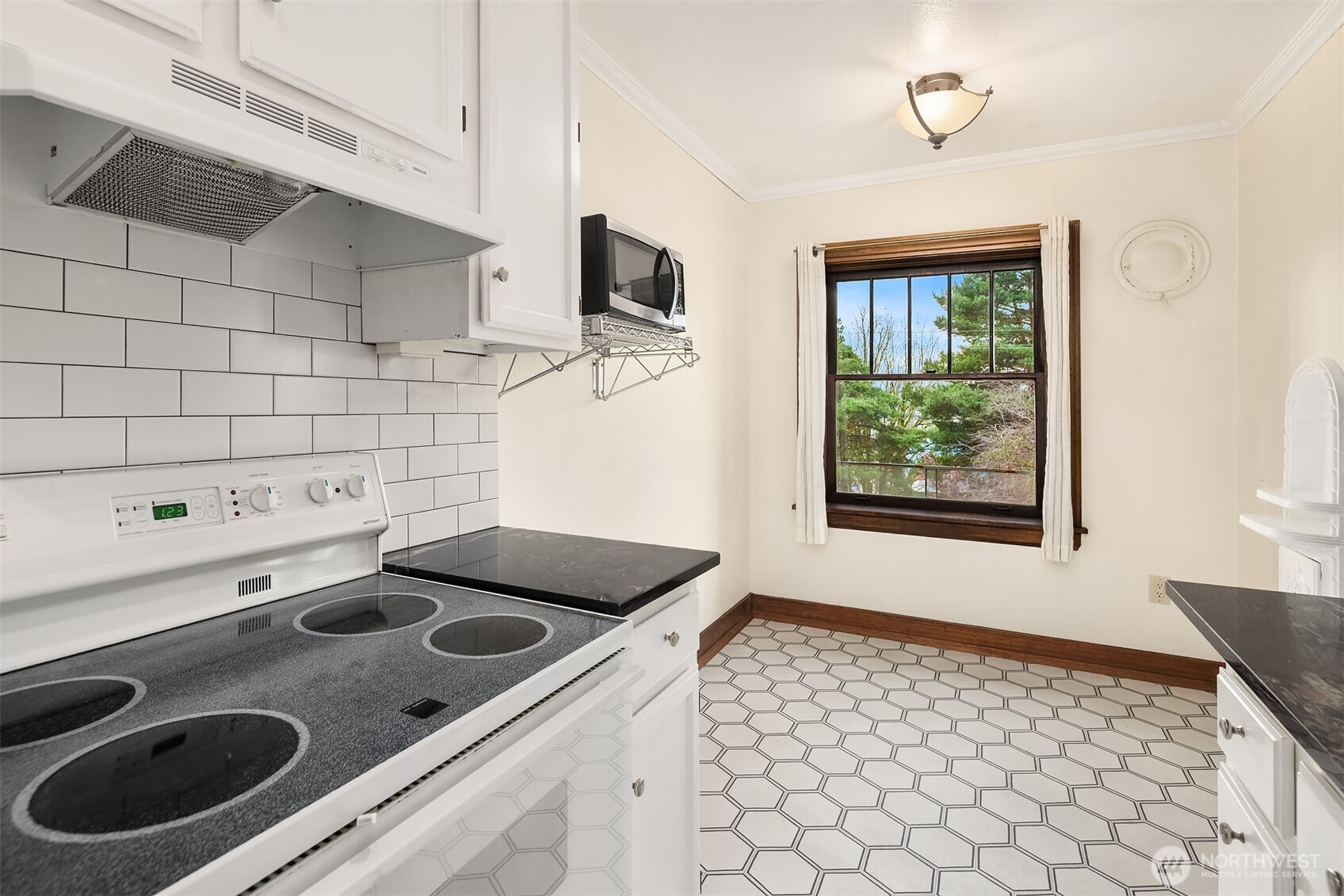 1631 16th Avenue, Unit 309 Seattle, WA 98122 - Photo 12 of 23 a kitchen with a sink appliances and cabinets