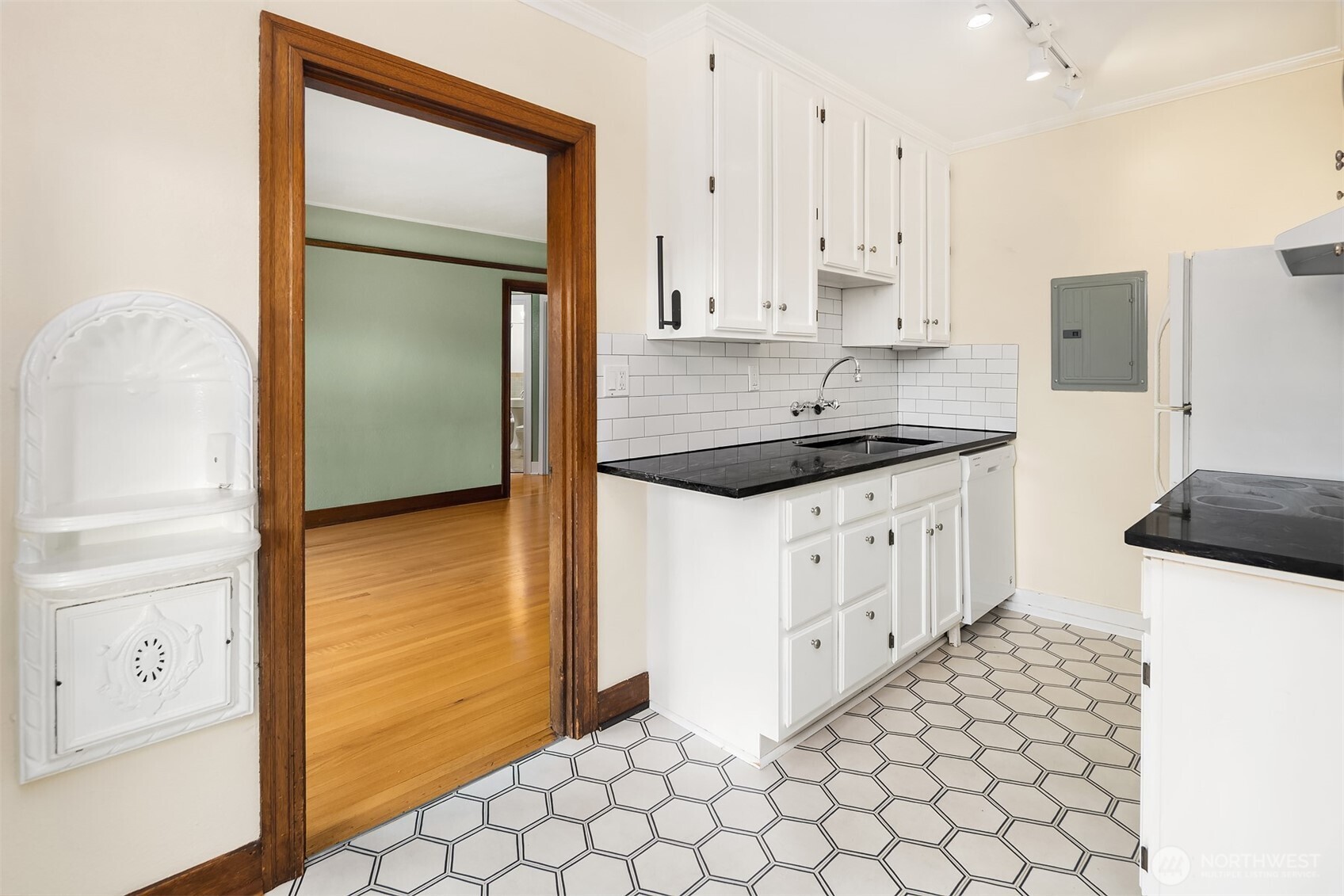 1631 16th Avenue, Unit 309 Seattle, WA 98122 - Photo 14 of 23 a kitchen with granite countertop white cabinets and white appliances