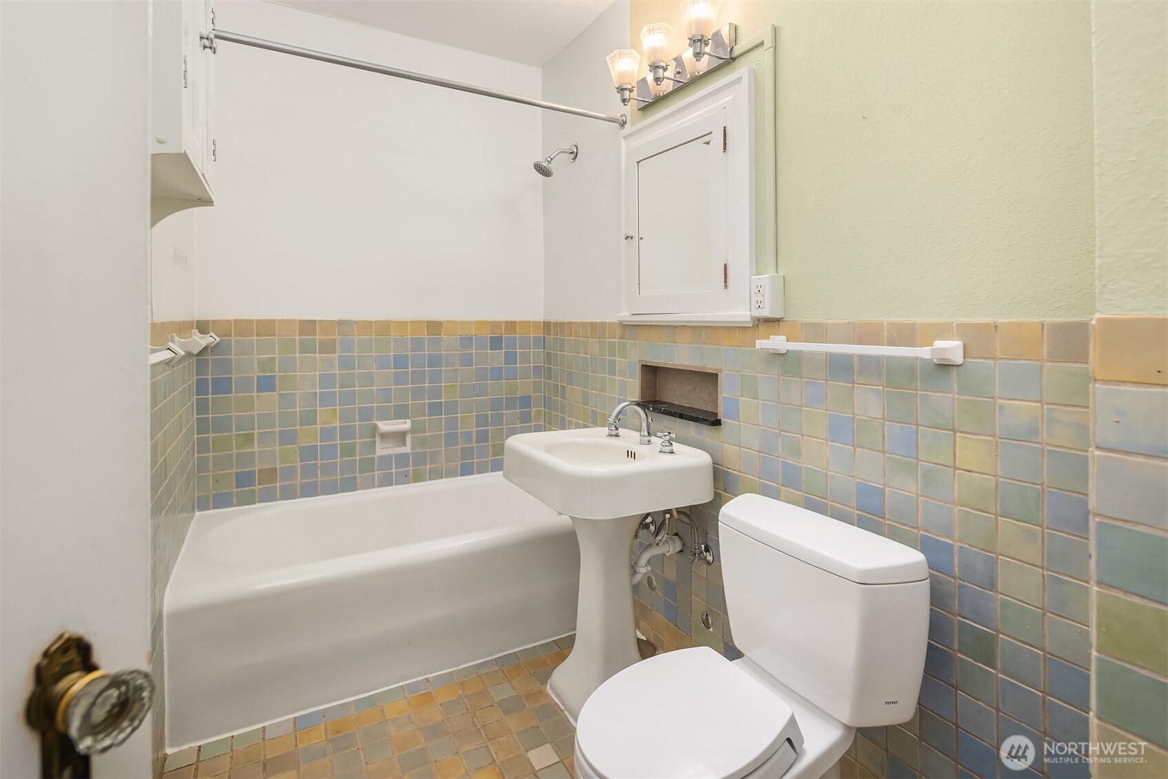 1631 16th Avenue, Unit 309 Seattle, WA 98122 - Photo 18 of 23 a bathroom with a sink a toilet and bathtub